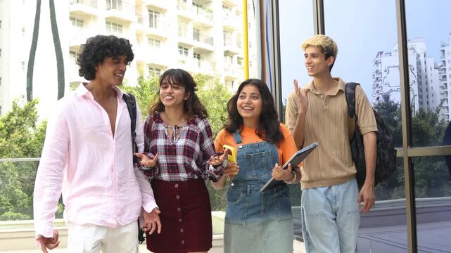 Diverse group of indian gen z college students enjoy conversing outdoors on campus, holding notebooks and wearing backpacks, representing education, friendship, and learning together