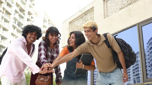 Young diverse indian students collaborating and stacking hands, teamwork, friendship, and togetherness on a college campus Education india.
