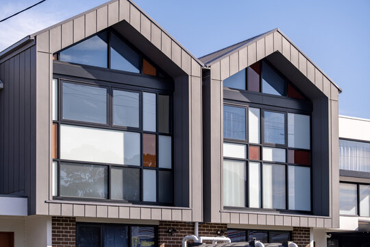 Modern architectural townhouse facade with&nbsp;geometric glass windows. New suburban and medium density housing in Australia. Real estate and  construction concepts