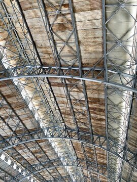 a classic industrial-style roof structure featuring a steel framework and rusted corrugated metal panels.