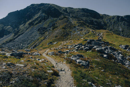 Old stony trail pathways winding across the mountain meadows of Romania.