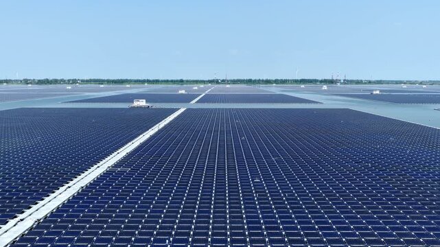 Expansive solar panel array under clear blue sky