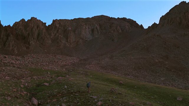 Hiker hiking saddle Mount Sneffels 14er peak landmark Wilderness Yankee Boy Basin trail trailhead Colorado Rockies landscape morning sunrise Ridgway Telluride Ouray San Juan Range Rocky Mountains