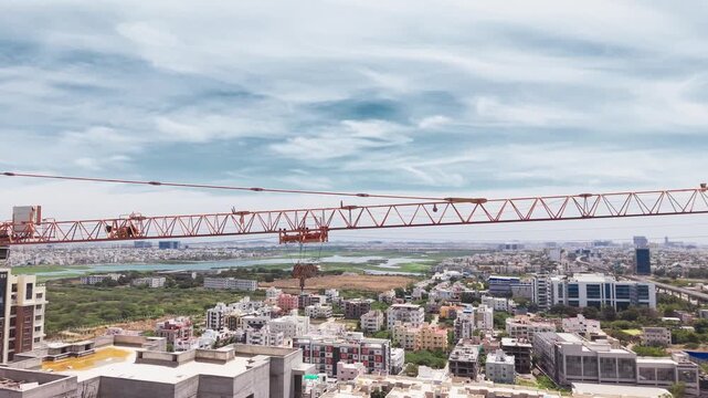 Tower crane arm extending over city skyline at construction site urban development infrastructure
