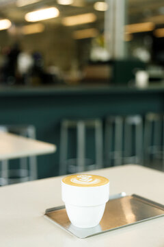Cup of hot milk coffee with latte art.