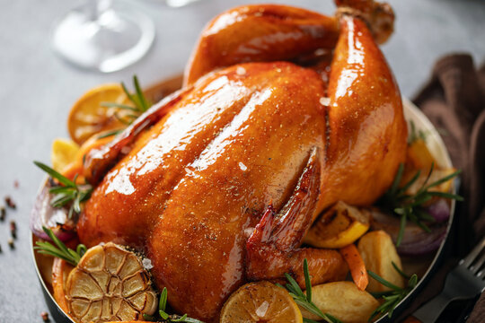 Fried chicken and vegetables on a black plate. Thanksgiving Day. Christmas dinner. Gray background.