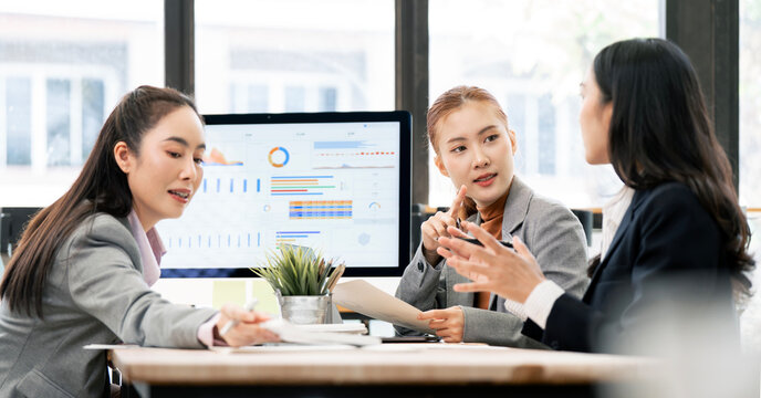 Asian Business Team Having Strategic Meeting and Data Analysis in Office
