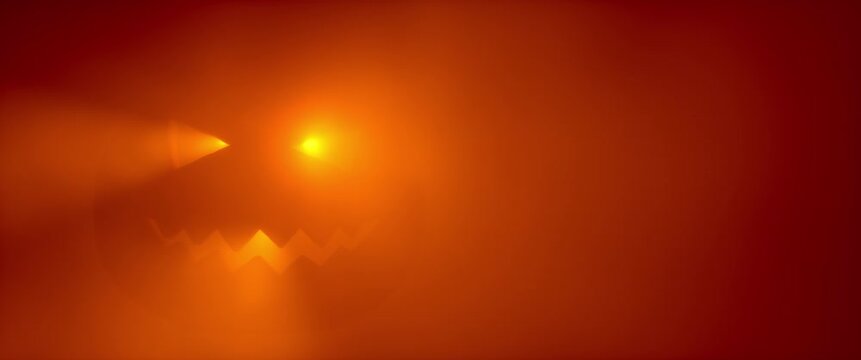 Glowing Halloween jack-o-lantern face in orange red fog with falling autumn leaves silhouettes. Spooky pumpkin glow atmospheric horror holiday background. Seamless loop 3d rendering animation.