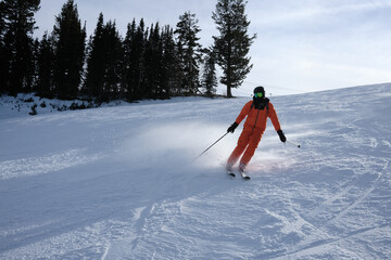Skier Spraying Snow While Turning on a Fresh Groomed Slope © Taras Vovchuk