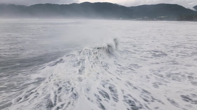 Drone Shot Flying Close To Large Storm Surge Waves Breaking Ashore