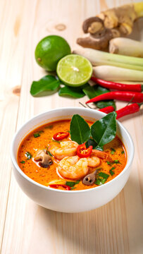 Spicy Thai tom yum goong soup in white bowl