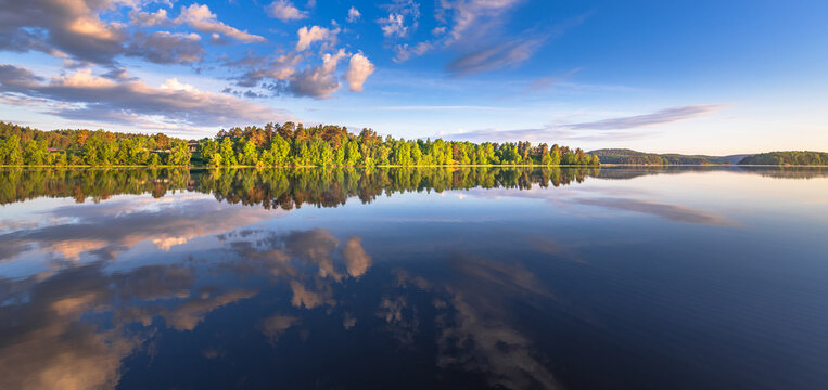 Still lake captures sky reflections at dawn