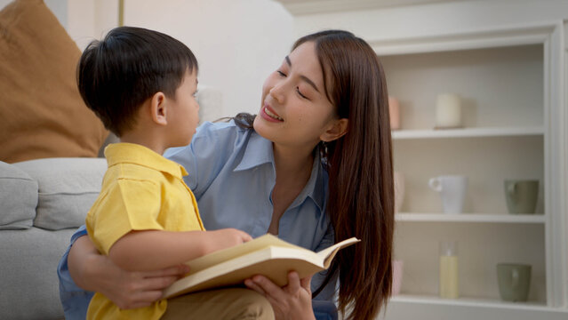 Mother reading a book with her child in a warm home setting