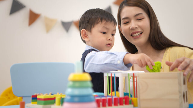 Mother guiding a child while playing educational toys, supporting learning and problem-solving skills
