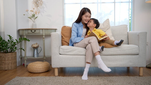 Mother reading a book with her child in a warm home setting