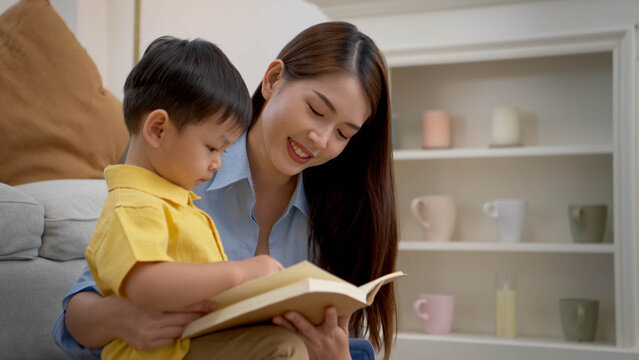 Mother reading a book with her child in a warm home setting
