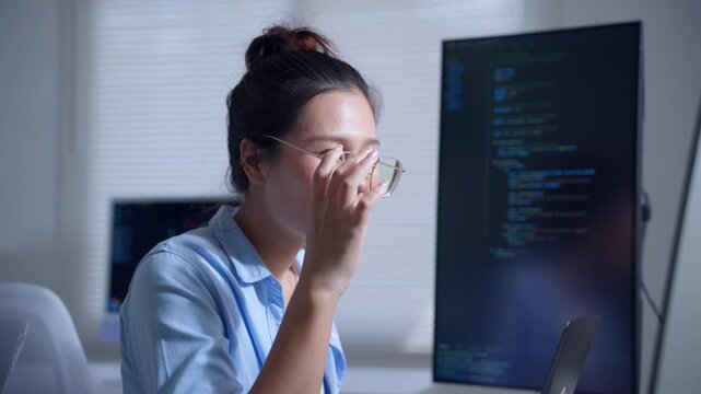 Stressed asian female programmer coding at night feeling tired and then solving a complex problem with satisfaction