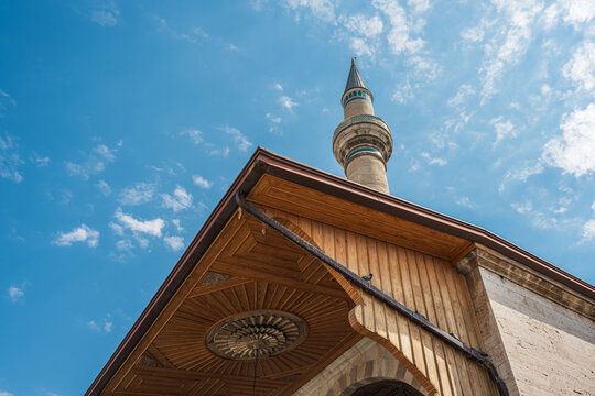 Minaret above traditional wooden eaves at Mevlana Museum in Konya Turkey