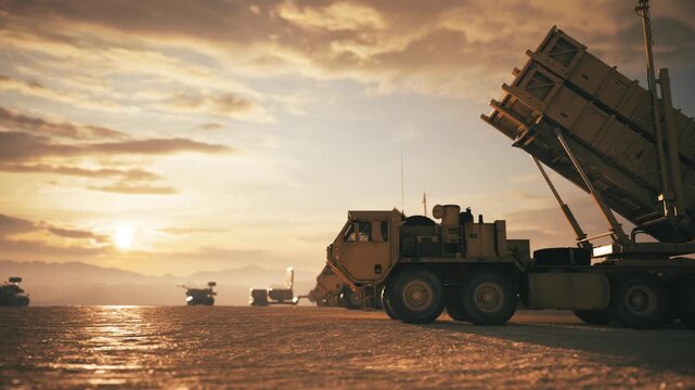 Military Missile Launchers and Armored Vehicles at Sunset. Patriot Air Defense Missile Systems