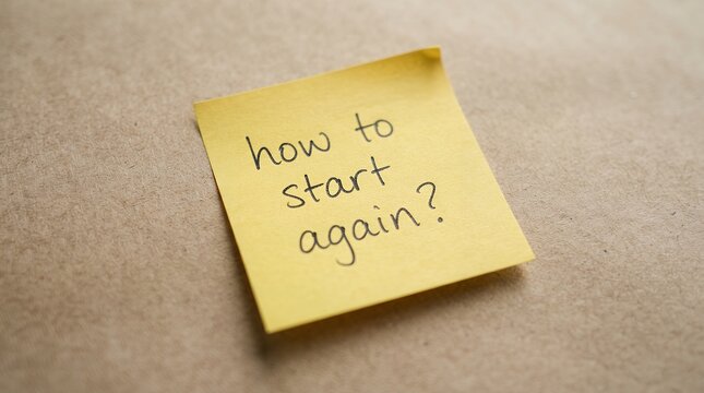 How to start again handwritten message on yellow sticky note, motivational question on adhesive paper, fresh start concept on brown background