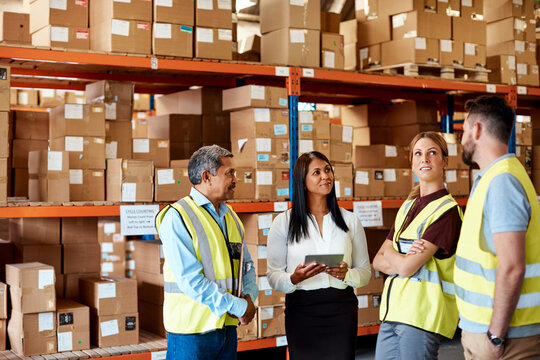 Logistics, manager or team in depot with tablet, stock control or task discussion in meeting. Happy, people or coordinator with tech, inventory management or dispatch instruction at storehouse.