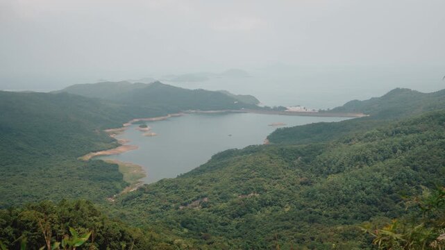 Shek Pik Reservoir, a scenic freshwater reservoir surrounded by lush mountains on Lantau Island in Hong Kong - Lantau Island, Hong Kong - 31 August 2026.