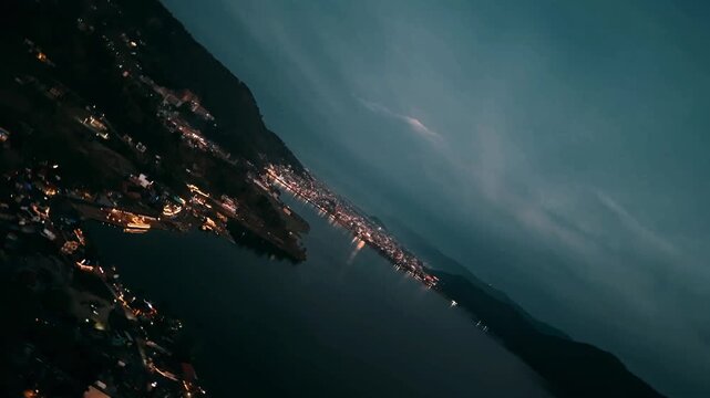 Rotating drone aerial of Phewa Lake and Pokhara at blue hour Nepal