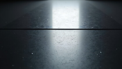 Fototapeta premium Abstract surface with reflective black texture and light streaks illuminating layout. Smooth black surface features subtle dust details, creating an elegant appearance in minimalistic visual design.