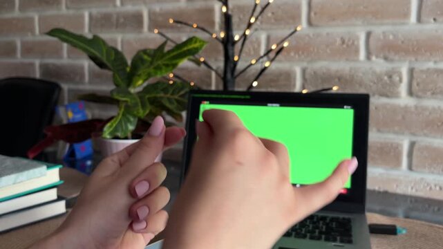 Patient gesticulating during an online therapy session with a psychologist on a laptop with a green screen, expressing emotions and discussing mental health issues