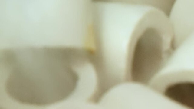 The scene shows cylindrical filter media in filtration equipment chamber. Within the same setting, many pale cylindrical and ring shaped packing elements are visible in close view.