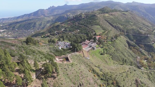 Aerial drone shot reveals the stunning mountain landscape of Gran Canaria, pulling back and booming up from Cruz de Tejeda.