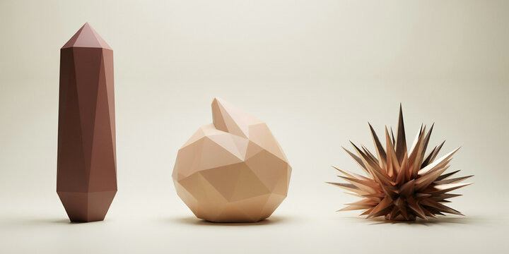 Three abstract geometric sculptures in brown, beige, and metallic bronze on a neutral