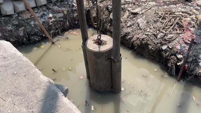 Traditional deep foundation pile driving at construction site
