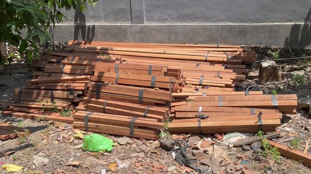 Bundles of wooden laths stacked at residential construction site