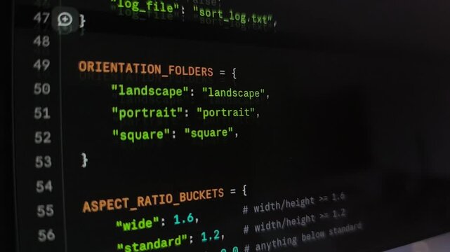 Rapid scrolling movement of colorful Python programming code text syntax on monitor. Advanced database software development compiler terminal interface layout. Digital application creation
