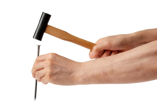 Male hands holding a hammer and a steel nail
