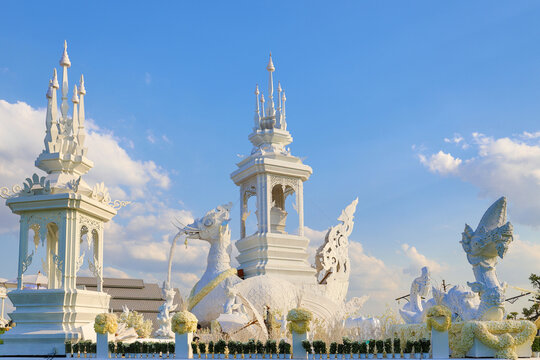 Elaborate white royal crematorium complex with spires and mythical creature sculptures.