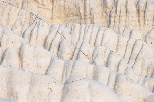 View of the white chalk formations of Tuzbair, featuring eroded ridges and textured limestone surfaces in the desert landscape of Mangystau District, Mangystau Region, Kazakhstan.