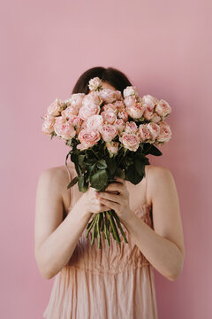 Woman in Pink Dress Holding Flower Bouquet
