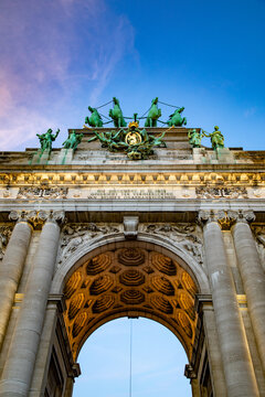 View of the Cinquantenaire Arch with its bronze quadriga sculpture and ornate neoclassical stone carvings under a clear blue sky in Brussels, Brussels, Belgium.