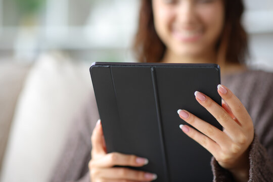 Woman hands holding and using tablet at home