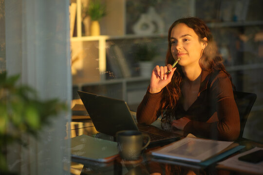 Young telecommuter thinking while working at home