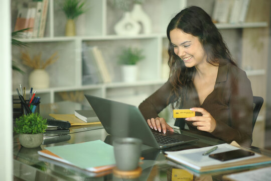 Happy telecommuter working at home buying online