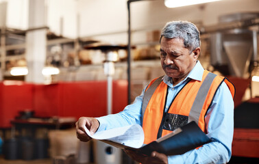 Clipboard, reading and wholesale with man in factory with manufacturing or production management. Information, inspection and order with mature person in industrial plant for checklist or schedule © peopleimages.com