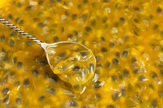 Teaspoon filled with juicy passion fruit pulp