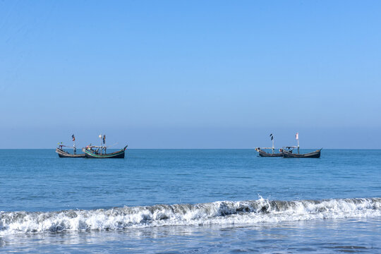 View of traditional wooden fishing boats on the calm blue sea at Saint Martin's Island West Beach, Cox's Bazar District, Chittagong Division, Bangladesh.