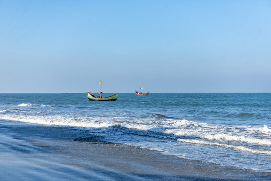 View of traditional wooden fishing boats sailing on the calm blue sea off the coast of Saint Martin's Island West Beach in Cox's Bazar District, Chittagong Division, Bangladesh.