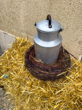 Old Aluminum Milk Can on Straw Bale at Autumn Market