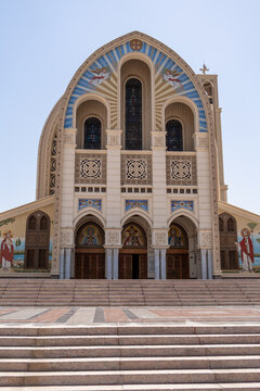 View of the Church of Saint Mary and Saint Mark in Coptic Cairo, featuring ornate facade, arched doorways, religious mosaics, and stone steps in Cairo, Cairo Governorate, Egypt.