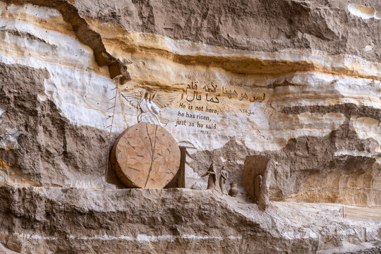 View of the rock-carved empty tomb of Jesus with an angel sculpture and biblical inscription at the Monastery of St. Simon the Tanner in Cairo, Cairo Governorate, Egypt.